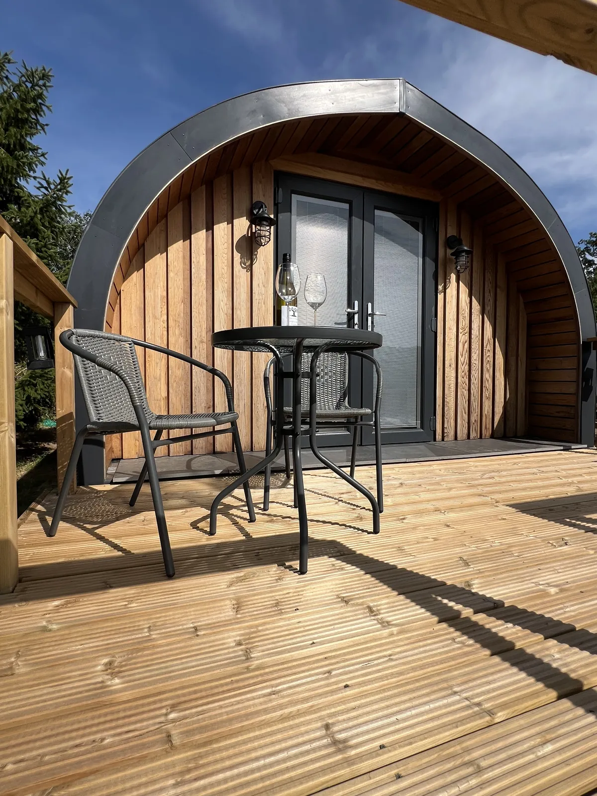 Table and two chairs on the Emily Pod decking
