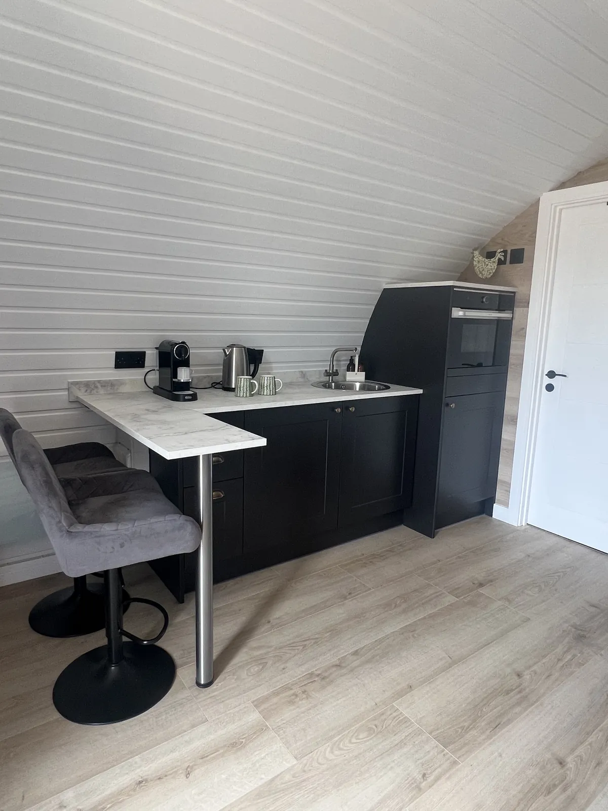 Emily Pod kitchenette with breakfast bar, sink and oven